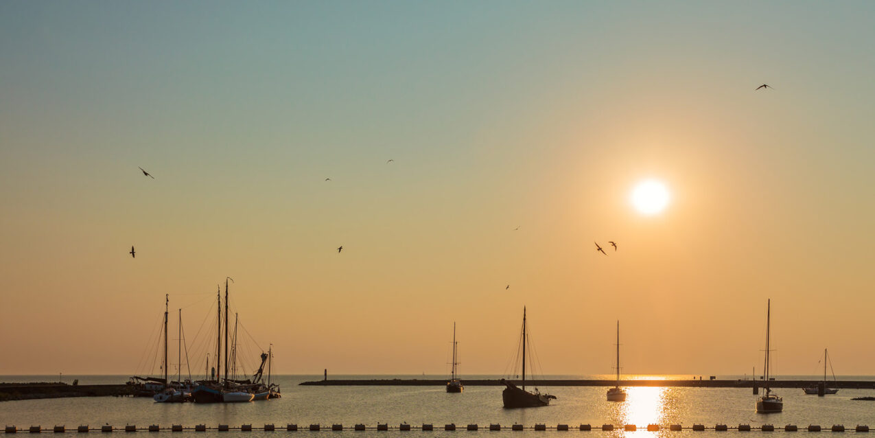 Zonsondergang met boten op de Friese wateren.